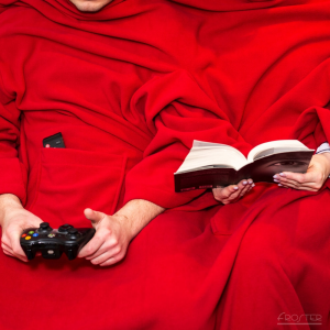 Małżeństwo spędza miło czas, będąc przykryte kocem z rękawami dla pary